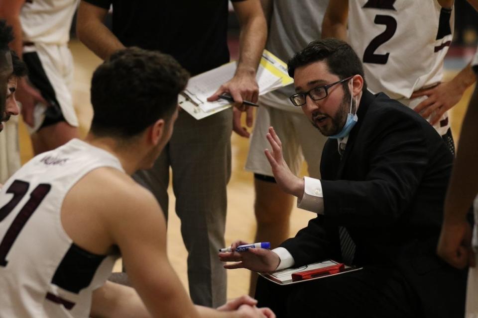 Sean McGee, 23, draws up a play during a timeout for his Manhattanville College men's basketball team in a Jan. 12, 2022 game against USMMA. The Poughquag native is an assistant who made his head coaching debut, filling in for Chris Alesi, who was quarantined with COVID-19.