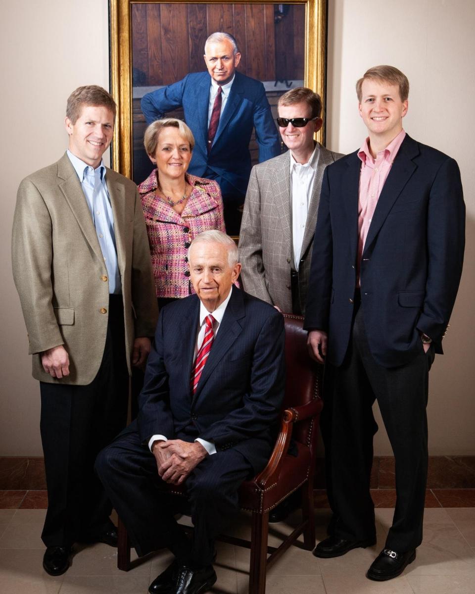 Bill Marriott poses with his children (L-R) John Marriott, Debbie Marriott, Stephen Marriott and David Marriott under a portrait of J.Willard Marriott 