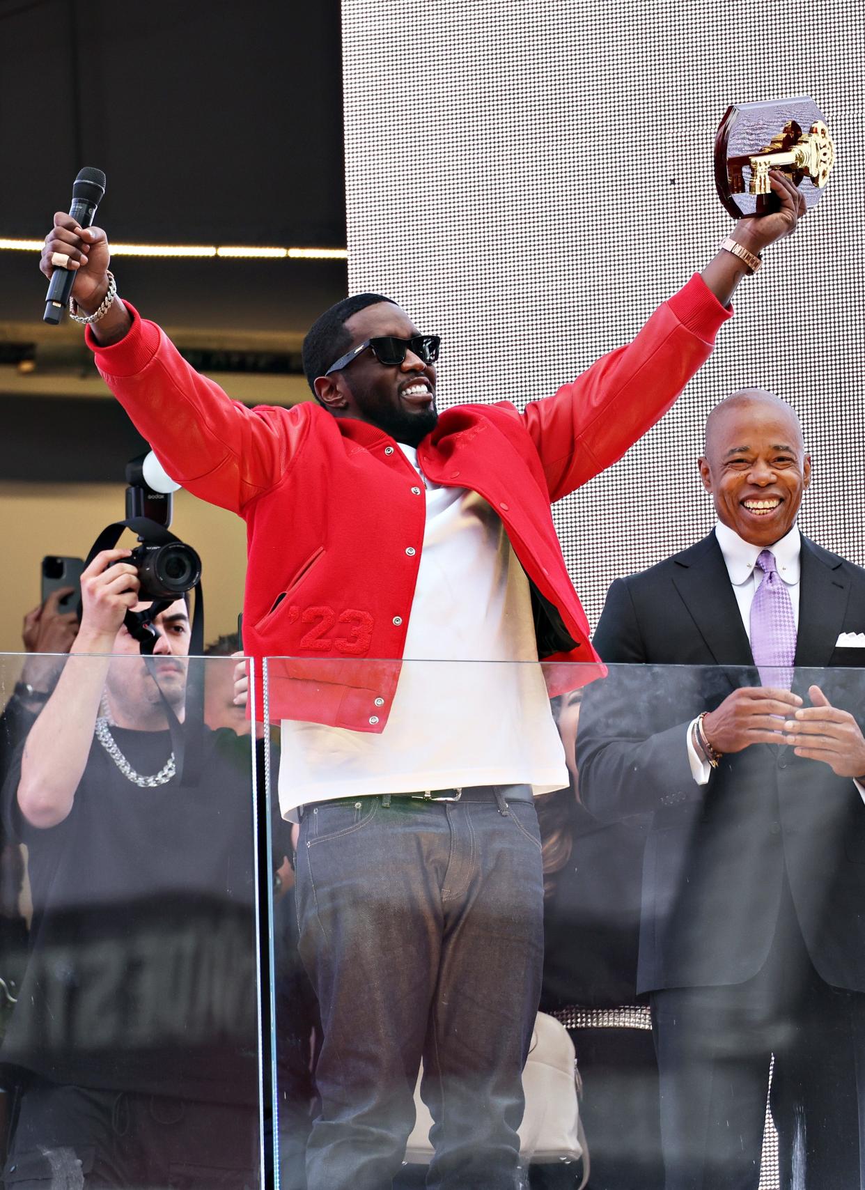 New York Mayor Eric Adams, right, presents Sean "Diddy" Combs with the keys to the city in Times Square on Sept. 15, 2023, in New York City.