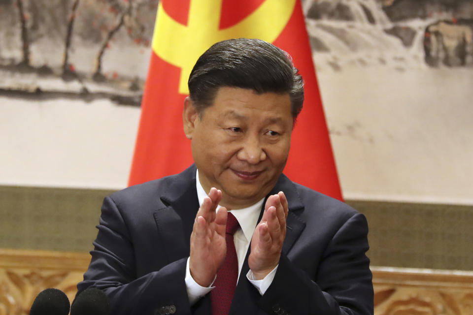 FILE - In this Oct. 25, 2017, file photo, Chinese President Xi Jinping claps while addressing the media as he introduces new members of the Politburo Standing Committee at Beijing's Great Hall of the People. Xi has an ambitious goal for China: to achieve "national rejuvenation" as a strong and prosperous nation by 2049, which would be the 100th anniversary of Communist Party rule. One problem: U.S. President Donald Trump wants to make the United States great again too. (AP Photo/Ng Han Guan, File)