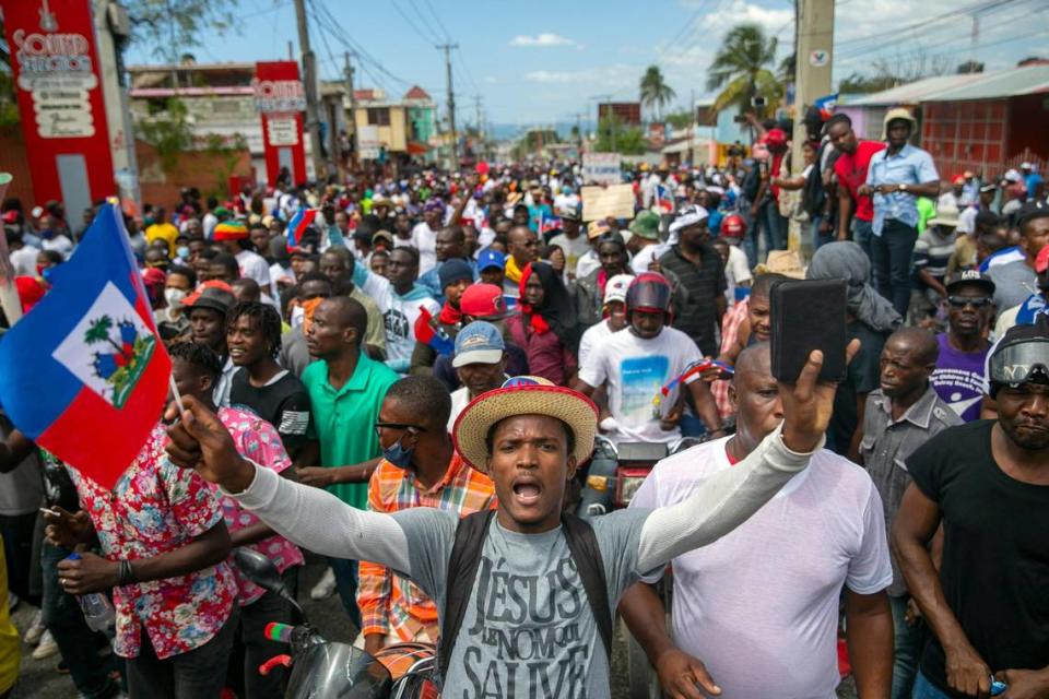 People protest to demand the resignation of Haitian President Jovenel Moise in Port-au-Prince, Haiti, Sunday, Feb. 28, 2021. The opposition is disputing the mandate of President Moise whose term they claim ended on Feb. 7, but the president and his supporters say his five-year term only expires in 2022.