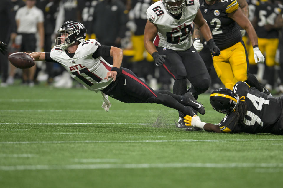 Atlanta Falcons quarterback Logan Woodside passes under pressure from Pittsburgh Steelers defensive tackle Armon Watts during the second half of a preseason NFL football game Thursday, Aug. 24, 2023, in Atlanta. (AP Photo/Hakim Wright Sr.)