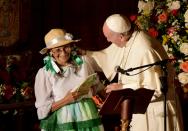 Pope Francis and a peasant smile during a meeting with political, economic and civil leaders at San Francisco Church in Quito, on July 7, 2015