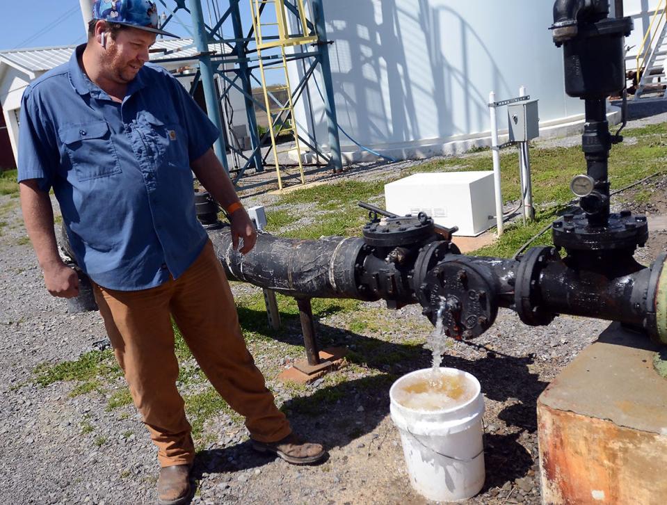 Jon Baldwin, treatment plant operator, sends an image of a sampling of water via cell phone to David Koehn, Black Bayou Water Association general manager, every morning, Friday, Mar. 25, 2022.