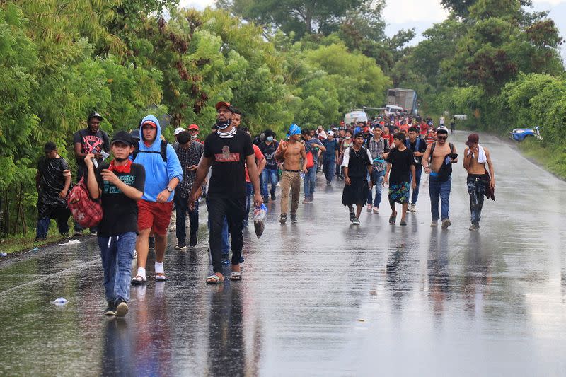Honduran migrants trying to reach the U.S. walk along a road after bursting through a border checkpoint to enter Guatemala illegally, in Entre Rios