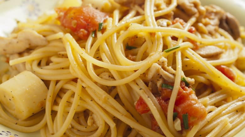 Close-up of hearts of palm in spaghetti with tomatoes and seasoning