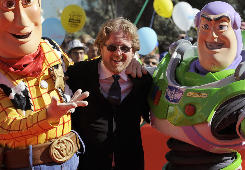 US director Andrew Stanton (C) is greeted by heroes of Toy Story, Woody (L) and Buzz Lightyear as he arrives for the ceremony for the Golden Lion for Lifetime Achievement ceremony at the Venice film festival on September 6, 2009.  The Golden Lion for Lifetime Achievement was awarded to US director John Lasseter and the Pixar directors. AFP PHOTO / Damien Meyer (Photo credit should read DAMIEN MEYER/AFP via Getty Images)