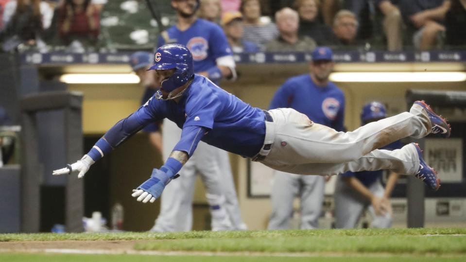 Chicago Cubs' Javier Baez scores during the fourth inning of a baseball game against the Milwaukee Brewers Wednesday, Sept. 5, 2018, in Milwaukee. Baez scored on a ball hit by Anthony Rizzo. (AP Photo/Morry Gash)