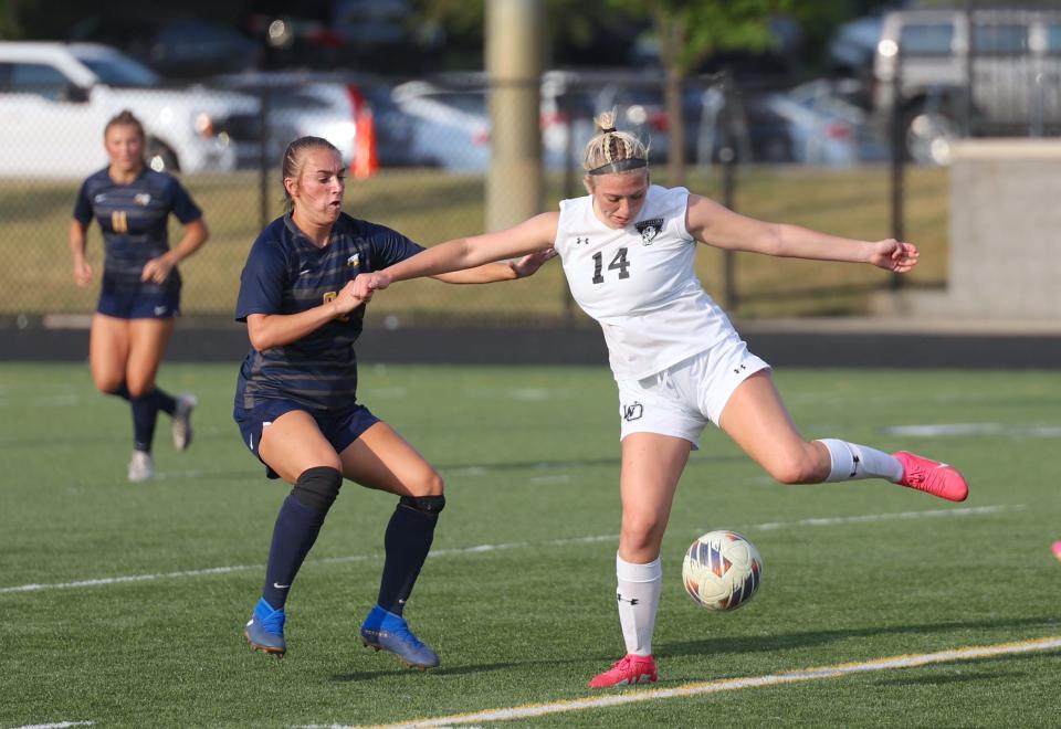 West Ottawa's Jillian Garcia, right, controls the ball during the district finals on Friday at Hudsonville.