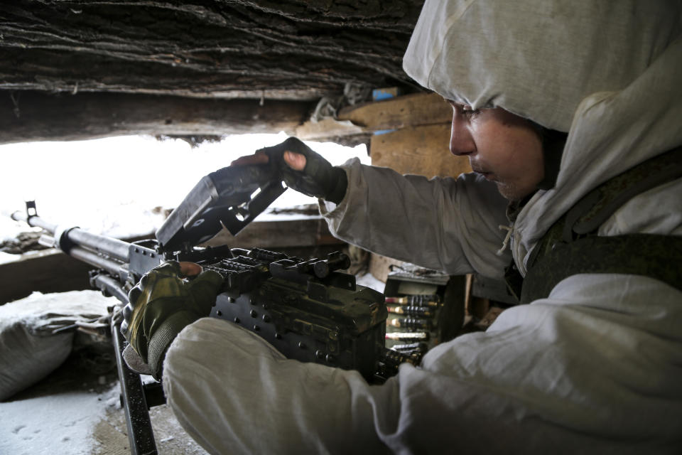 A serviceman checks his machine-gun in a shelter on the territory controlled by pro-Russian militants at frontline with Ukrainian government forces in Slavyanoserbsk, Luhansk region, eastern Ukraine, Tuesday, Jan. 25, 2022. Ukraine's leaders sought to reassure the nation that a feared invasion from neighboring Russia was not imminent, even as they acknowledged the threat is real and prepared to accept a shipment of American military equipment Tuesday to shore up their defenses. (AP Photo/Alexei Alexandrov)