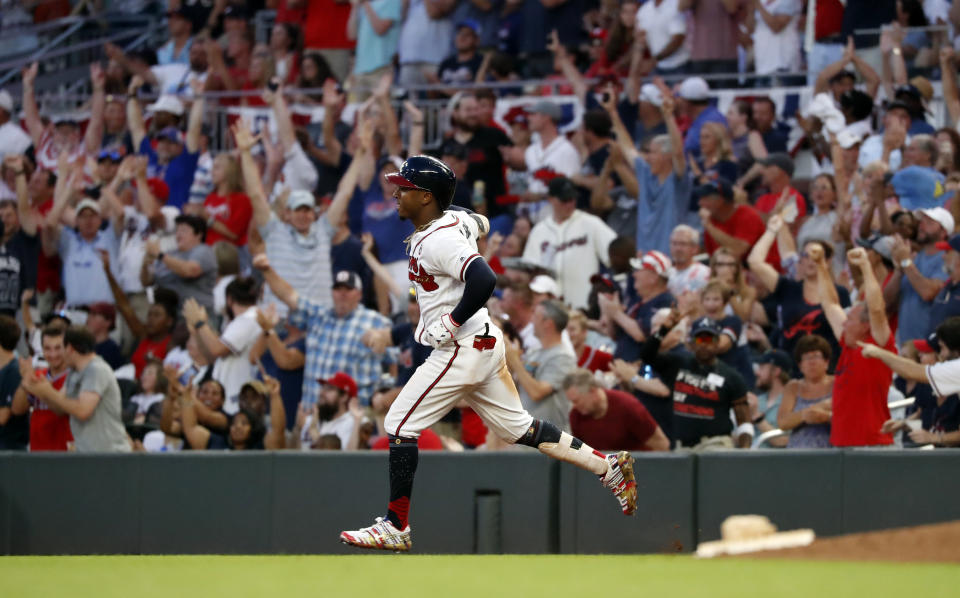 FILE - In this July 4, 2019, file photo, Atlanta Braves' Ozzie Albies rounds first base after hitting a three-run home run during the third inning of the team's baseball game against the Philadelphia Phillies in Atlanta. Major League Baseball owners gave the go-ahead Monday, May 11, 2020, to making a proposal to the players’ union that could lead to the coronavirus-delayed season starting around the Fourth of July weekend in ballparks without fans, a plan that envisioned expanding the designated hitter to the National League for 2020. (AP Photo/John Bazemore, File)