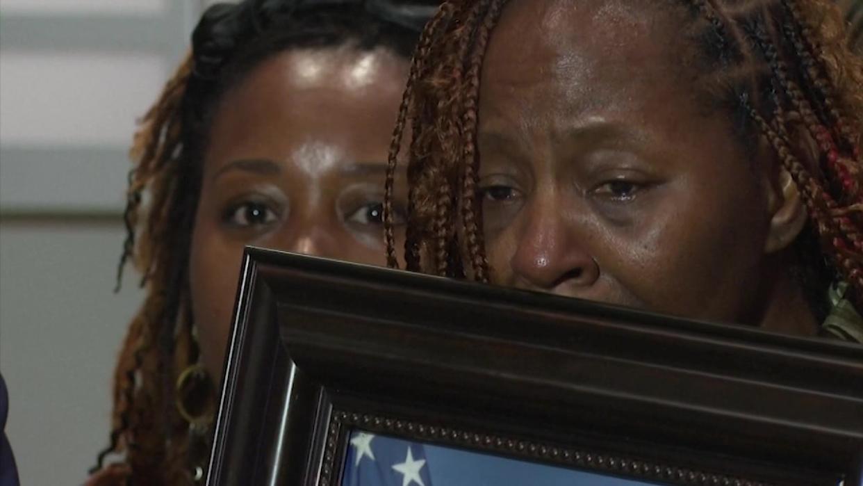 <div>U.S. Airman Roger Fortson's mother cries as she holds a photo of her son.</div>