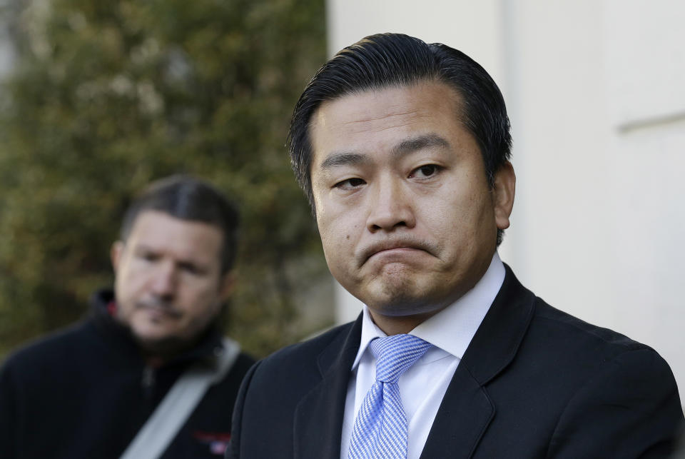 Wang Chuan, spokesperson for the Chinese Consulate, speaks outside of the damaged entrance to the consulate in San Francisco on Thursday, Jan. 2, 2014. The consulate said Thursday that its compound was damaged in an arson attack and urged American authorities to protect the safety of its diplomats and its premises. (AP Photo/Jeff Chiu)