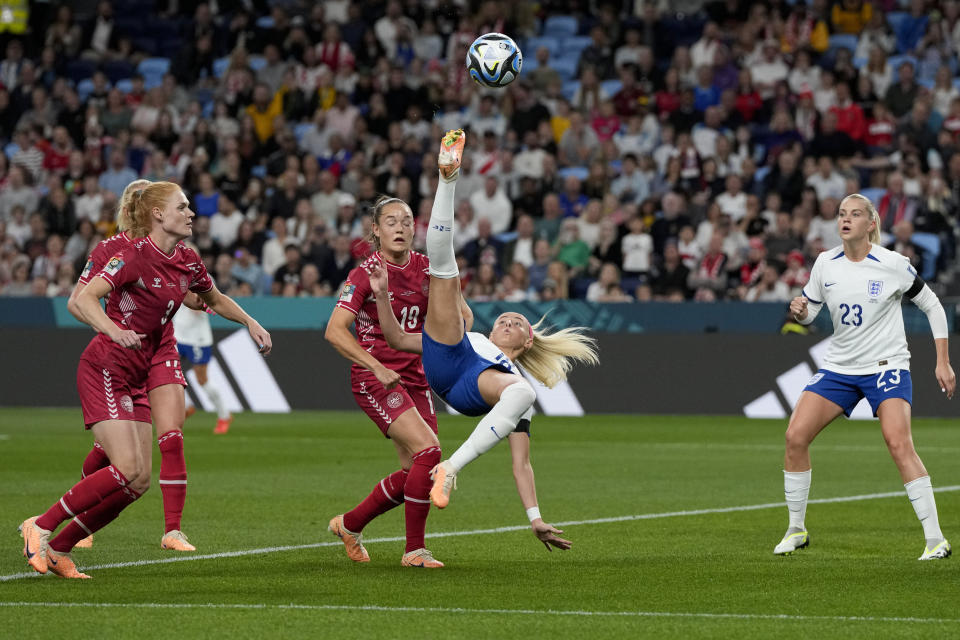 England's Chloe Kelly attempts a bicycle kick next to Denmark's Janni Thomsen during the Women's World Cup Group D soccer match between England and Denmark at the Sydney Football Stadium in Sydney, Australia, Friday, July 28, 2023. (AP Photo/Mark Baker)
