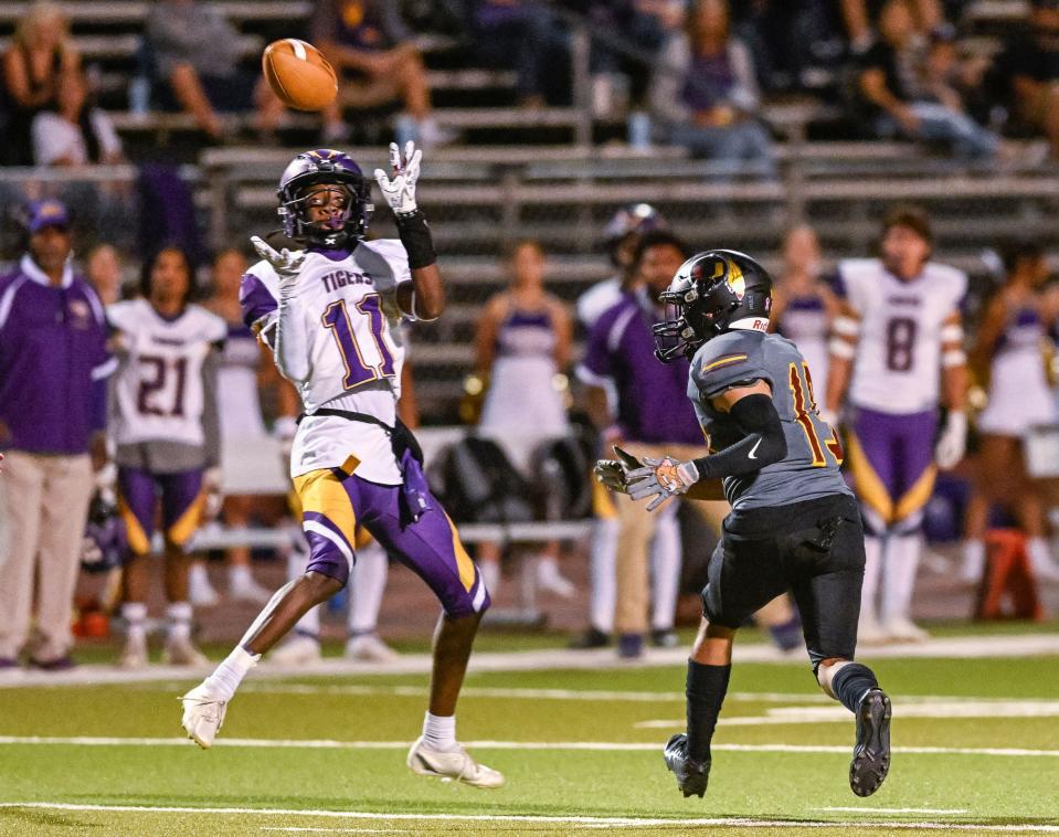 Lemoore's Kiontre Harris takes a pass under pressure from Tulare Union's Jaelin Dominguez in a West Yosemite League high school football game Thursday, September 28, 2023.