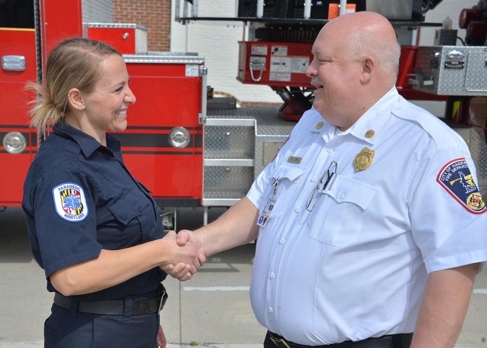 In this Herald-Mail file photo, Hagerstown Fire Chief Steve Lohr congratulates Deanna Pelton on her promotion to become the city's next deputy fire marshal in 2019. At the time, Pelton was the department's only female career firefighter and its first female fire marshal. Pelton has been with the department since 2006. Her new role started on July 1, 2019.