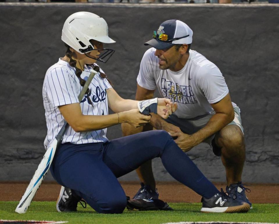 Keller head coach Chad Cribbs talks to catcher Kyla Fabela (14) before her at-bat during the Conference 6A Region 1 Regional Finals at Coppell Softball Field in Coppell, Texas, Saturday May 25, 2024.