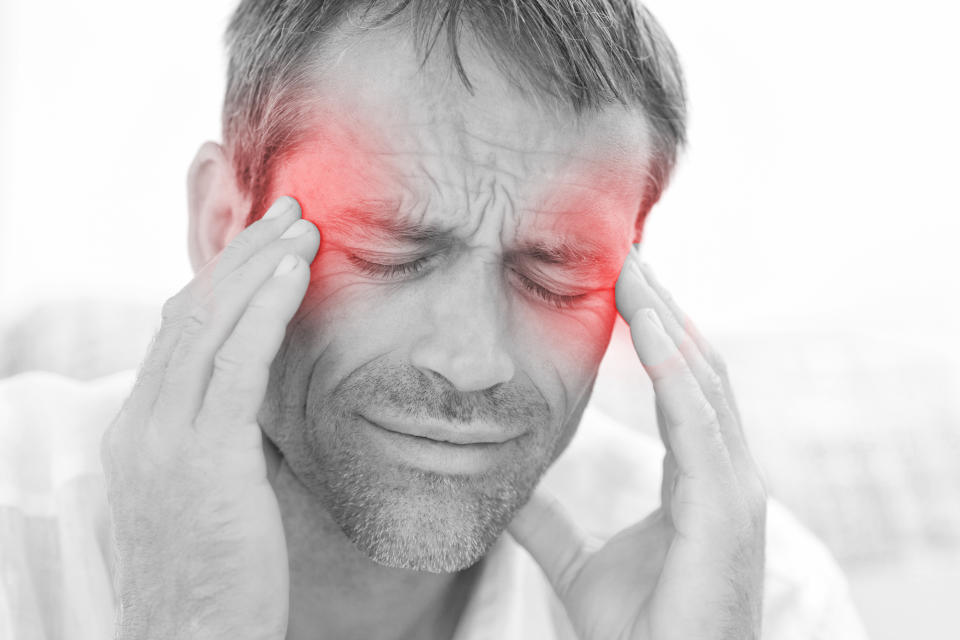 Man having a headache at home