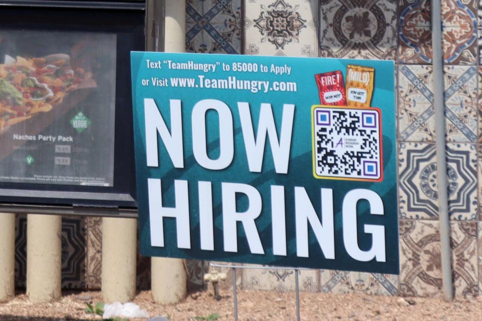 A "now hiring" sign sits next to the drive-thru menu at Taco Bell, 3309 S Washington St. in Amarillo.
