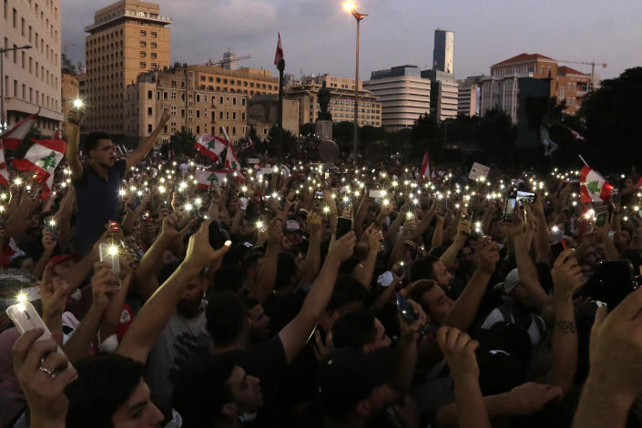 Protesters fresh their smartphone's lights during a protest against the Lebanese government in Beirut, Lebanon, Saturday, Oct. 19, 2019. The blaze of protests was unleashed a day earlier when the government announced a slate of new proposed taxes, including a $6 monthly fee for using Whatsapp voice calls. The measures set a spark to long-smoldering anger against top leaders from the president and prime minister to the numerous factional figures many blame for decades of corruption and mismanagement. (AP Photo/Hassan Ammar)