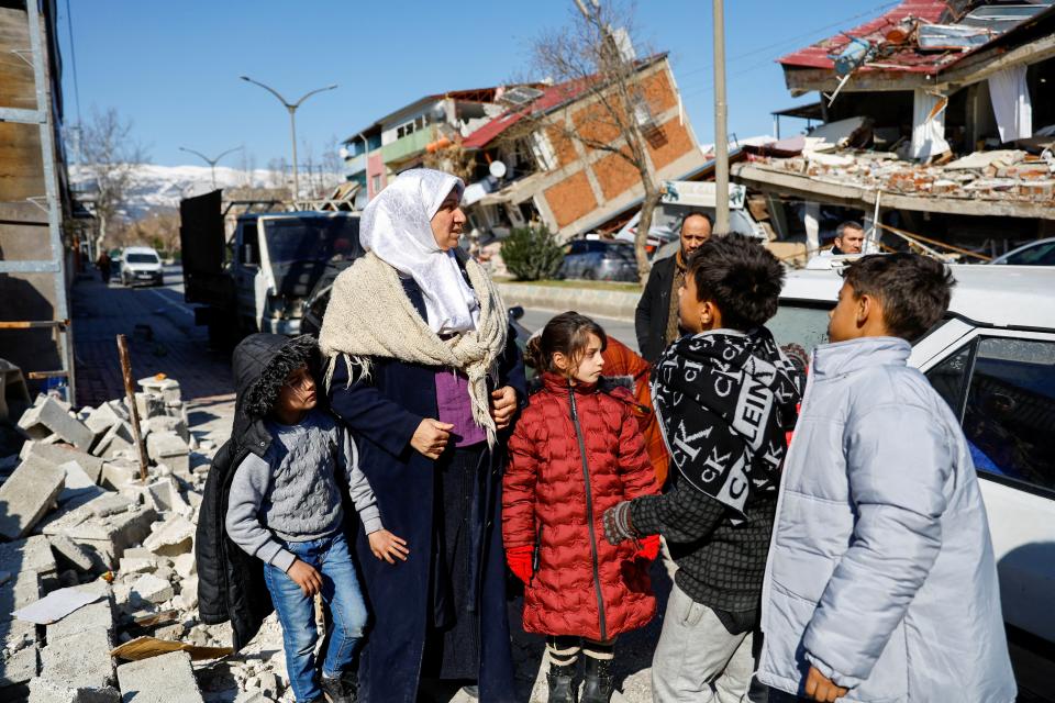 Members of a Syrian family, whose house was destroyed during the war in Syria and later moved to Turkey, gather after their house in Turkey was destroyed in the deadly earthquake, in Kahramanmaras (REUTERS)