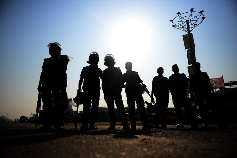 Bangladesh police personnel stand guard during a nationwide strike in Dhaka on February 24, 2013. Islamists demanding the execution of bloggers they accuse of blasphemy clashed with police in Bangladesh for a third straight day Sunday, and at least four protesters were killed when police opened fire