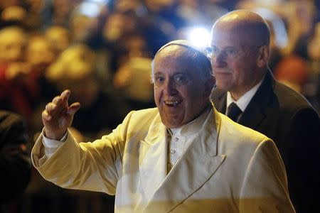 Pope Francis waves as he leaves after visiting the parish of San Michele Archangelo in Rome February 8, 2015. REUTERS/Giampiero Sposito