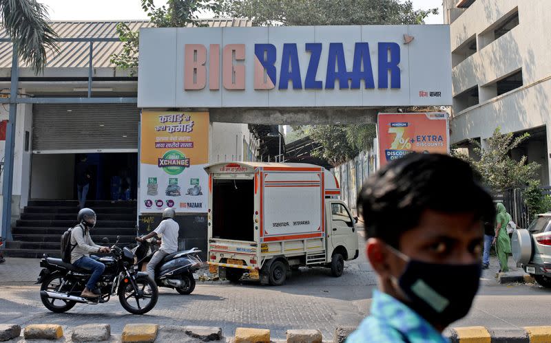 FILE PHOTO: People move past a Future Retail's closed Big Bazaar retail store in Mumbai