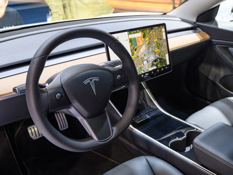 Tesla Model 3 compact full electric car interior with a large touch screen on the dashboard on display at Brussels Expo on JANUARY 09, 2020 in Brussels, Belgium. The Model 3 is fitted with a full self-driving system.