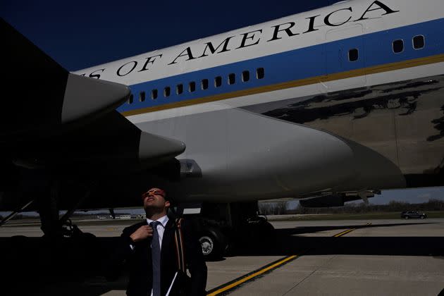 A White House staffer looks up to the sky as a total eclipse of the sun arrives at Dane County Regional Airport in Madison, Wisconsin, on April 8, 2024. (Photo by ANDREW CABALLERO-REYNOLDS/AFP via Getty Images)