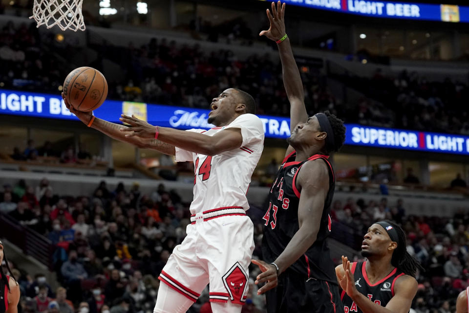 Chicago Bulls' Javonte Green (24) scores past Toronto Raptors' Pascal Siakam during the second half of an NBA basketball game Wednesday, Jan. 26, 2022, in Chicago. The Bulls won 111-105. (AP Photo/Charles Rex Arbogast)