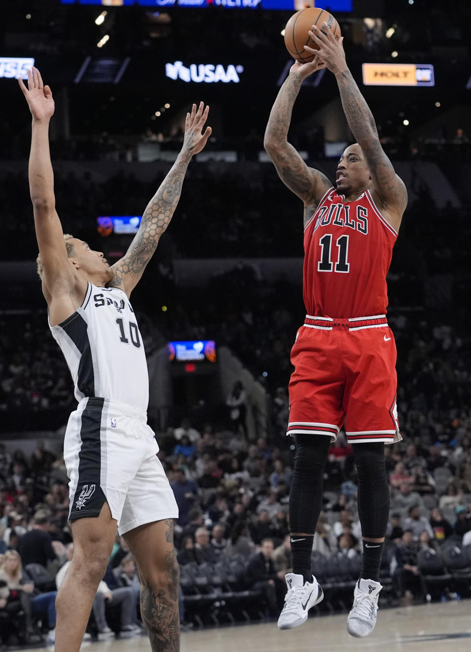 Chicago Bulls forward DeMar DeRozan (11) shoots over San Antonio Spurs forward Jeremy Sochan (10) during the second half of an NBA basketball game in San Antonio, Saturday, Jan. 13, 2024. (AP Photo/Eric Gay)