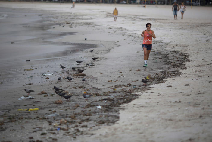 <p>A woman runs next to the trash that litters the Botafogo beach next to the Sugar Loaf mountain and the Guanabara Bay in Rio de Janeiro, Brazil, Saturday, July 30, 2016. An Associated Press investigation has found the waters where Olympians will compete in swimming and boating events next summer in South America’s first games are rife with human sewage and present a serious health risk for athletes.(AP Photo/Leo Correa)