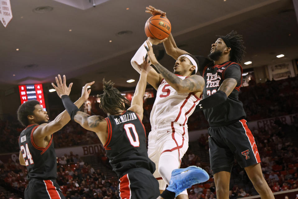 Texas Tech forward Warren Washington, right, blocks a shot-attempt by Oklahoma guard Rivaldo Soares (5) near Texas Tech guards Kerwin Walton (24) and Chance McMillian (0) during the second half of an NCAA college basketball game Saturday, Jan. 27, 2024, in Norman, Okla. (AP Photo/Nate Billings)