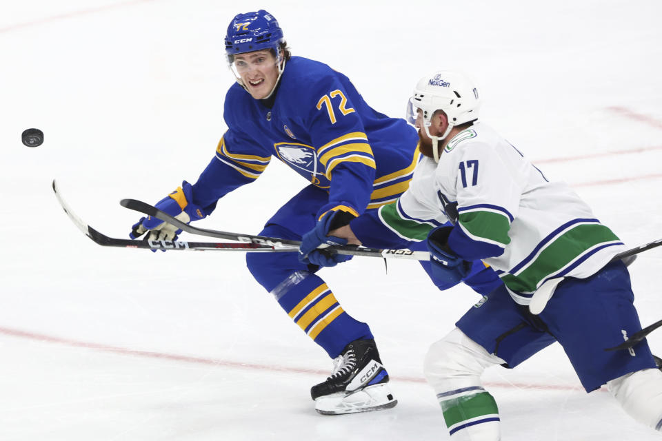 Buffalo Sabres right wing Tage Thompson (72) and Vancouver Canucks defenseman Filip Hronek (17) chase the puck during the third period of an NHL hockey game Saturday, Jan. 13, 2024, in Buffalo, N.Y. (AP Photo/Jeffrey T. Barnes)