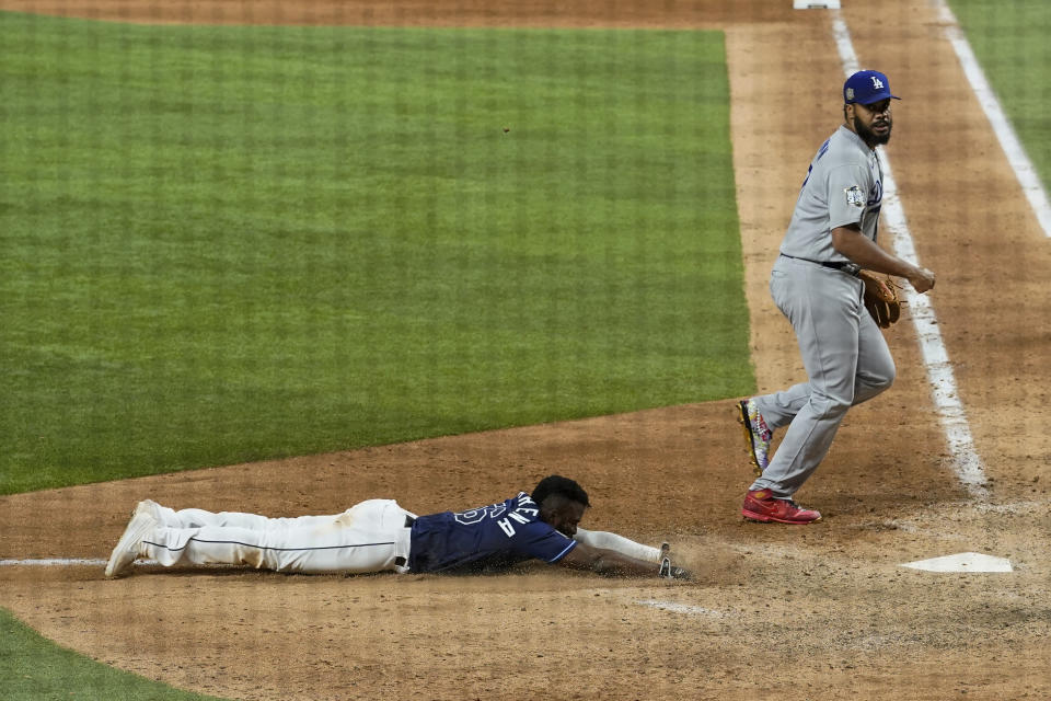 Tampa Bay Rays' Randy Arozarena, left, scores the winning run past Los Angeles Dodgers relief pitcher Kenley Jansen in Game 4 of the baseball World Series Saturday, Oct. 24, 2020, in Arlington, Texas. Rays defeated the Dodgers 8-7 to tie the series 2-2 games. (AP Photo/Eric Gay)