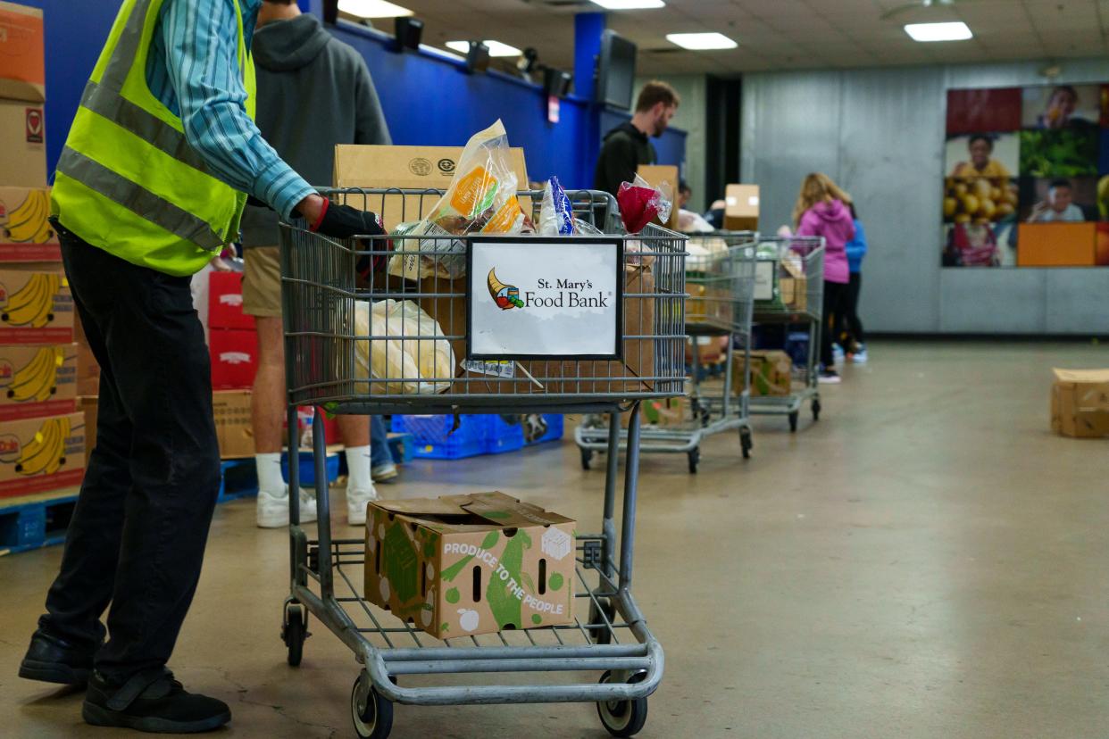Volunteers prep shopping carts full of food to be handed out at St. Mary's Food Bank on Dec. 30, 2022, in Phoenix, Ariz.