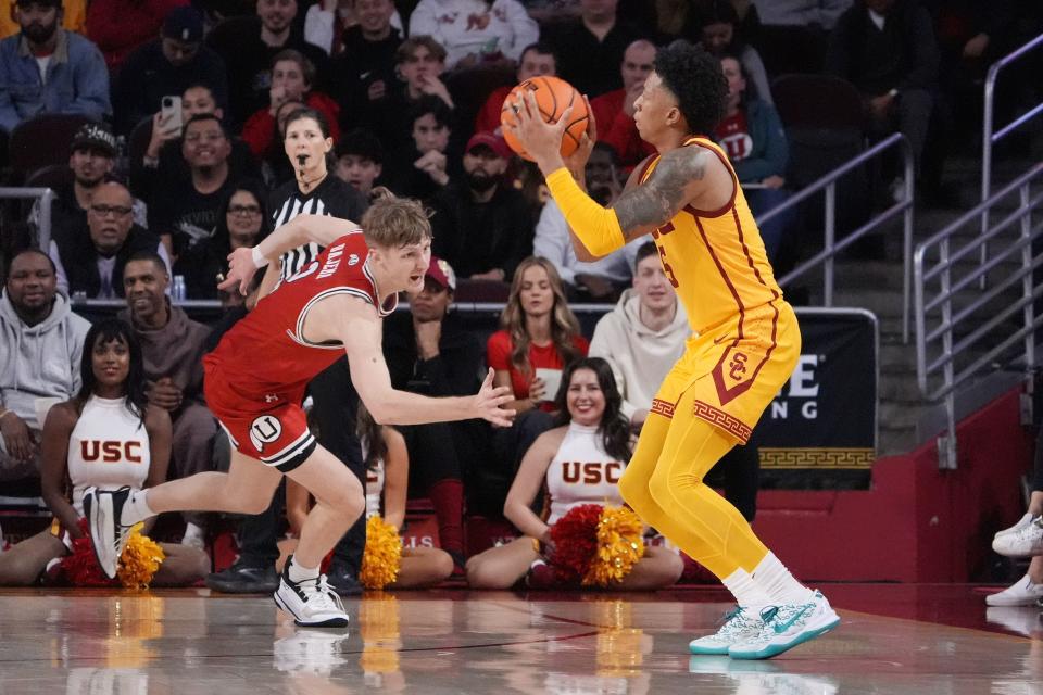 Southern California guard Boogie Ellis, right, shoots as Utah guard Cole Bajema defends during the second half of an NCAA college basketball game Thursday, Feb. 15, 2024, in Los Angeles. | Mark J. Terrill, Associated Press