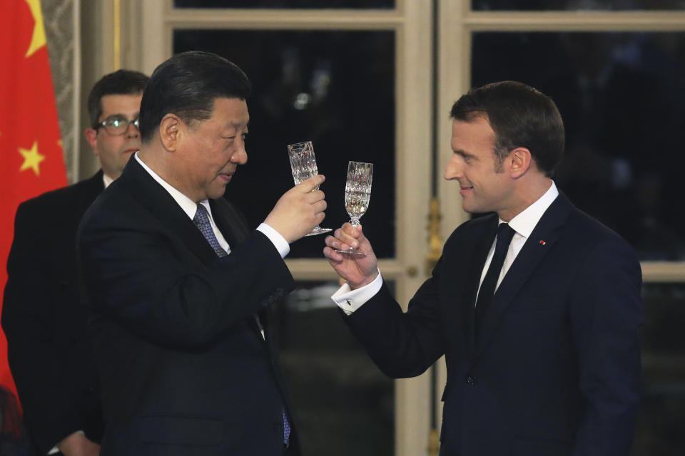 French President Emmanuel Macron, right, and Chinese President Xi Jinping share a toast during a state dinner at the Elysee Palace in Paris, France, Monday, March 25, 2019. Chinese President Xi Jinping is on a 3-day state visit in France where he is expected to sign a series of bilateral and economic deals on energy, the food industry, transport and other sectors. (Ludovic Marin/Pool Photo via AP)