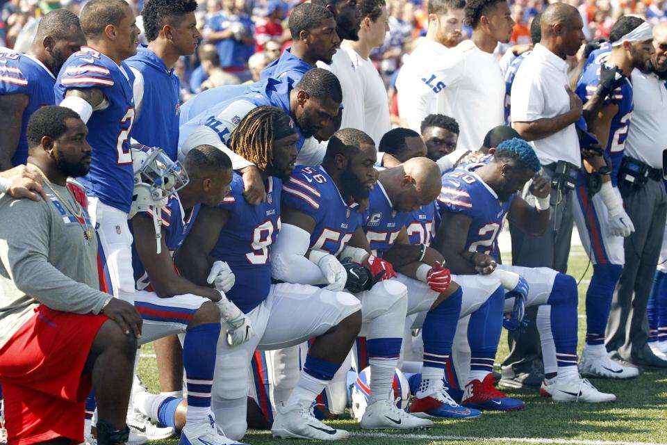 Buffalo Bills players take a knee during the playing of the national anthem prior to an NFL football game against the Denver Broncos in New York: AP