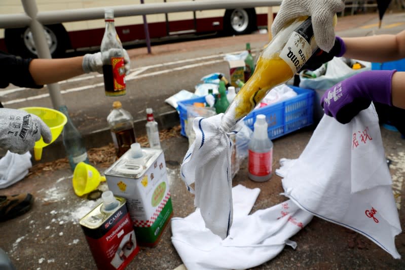 FILE PHOTO: Anti-government protesters make Molotov cocktails during a protest at the Chinese University of Hong Kong, Hong Kong