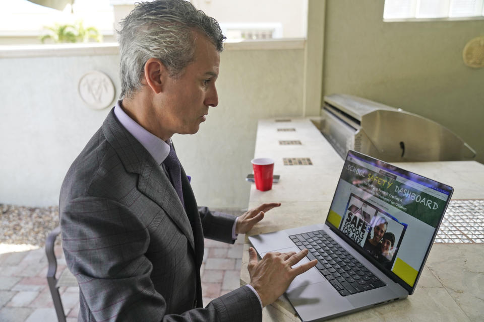 Max Schachter shows an online dashboard where parents in several states can examine safety data for their child's school, during an interview, Monday, Jan. 30, 2023, at his home in Coral Springs, Fla. Schachter, whose 14-year-old son, Alex, was killed at Parkland's Marjory Stoneman Douglas High School shooting five years ago, ended his insurance practice and made promoting school safety his full-time mission. He started Safe Schools for Alex. The foundation's website includes the dashboard. (AP Photo/Wilfredo Lee)