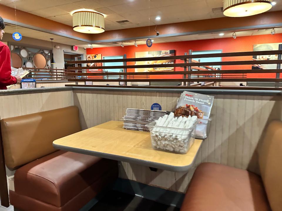 small both at ihop with wood table and cushioned benches