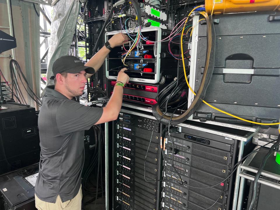 Justin Tart, a senior majoring in video and film production from Lebanon, Tennessee, checks equipment Wednesday, June 15, behind The Other stage in preparation to provide video and streaming services for upcoming performances at the 2022 Bonnaroo Music and Arts Festival June 16-19 in Manchester, Tenn.