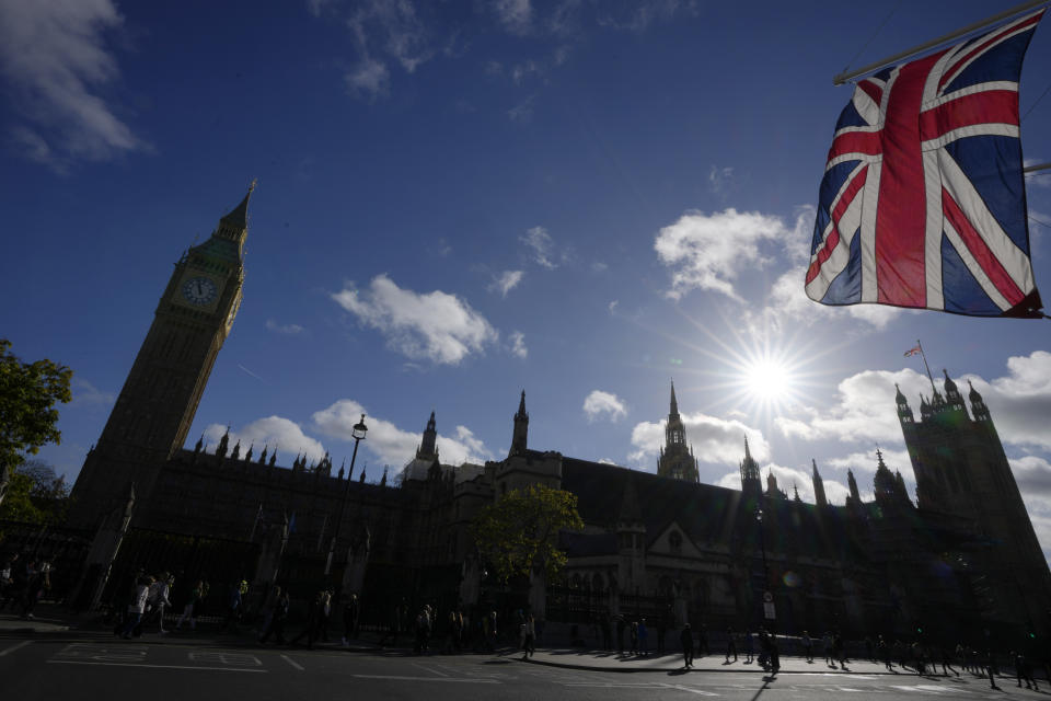 FILE - The Union flag flaps in the wind outside the Houses of Parliament in London, Monday, Oct. 24, 2022. Britain’s governing Conservative Party said Thursday, April 18, 2024, it has suspended a lawmaker who is alleged to have used campaign funds for personal medical expenses and to pay off someone who was threatening him. The case is the latest allegation of sleaze to hit the Conservatives, who have lost several lawmakers to ethics scandals in the past two years – including former Prime Minister Boris Johnson. (AP Photo/Kirsty Wigglesworth, file)