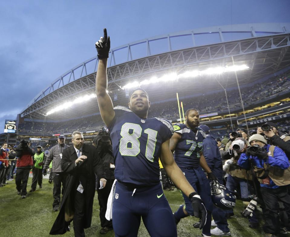 Seattle Seahawks wide receiver Golden Tate celebrates after an NFC divisional playoff NFL football game against the New Orleans Saints in Seattle, Saturday, Jan. 11, 2014. The Seahawks won 23-15. (AP Photo/Elaine Thompson)