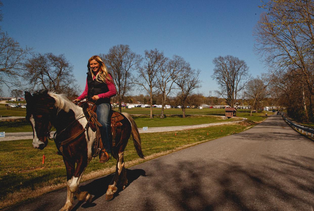 A woman rides her horse through the Maury County Park during the annual Mule Day event in Columbia, Tenn. on Mar. 29, 2023. Mule Day is an annual event in its 49th year that celebrates Columbia's history as a world renowned mule trading post.