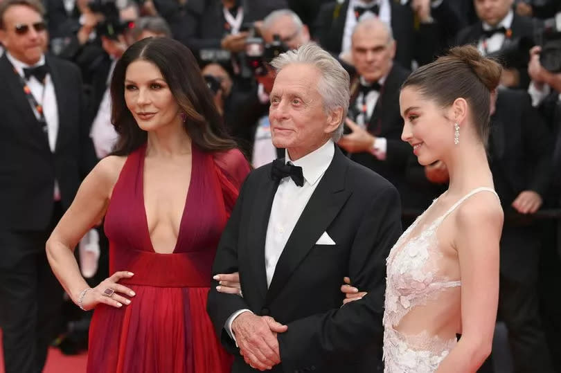 Carys (right) with her famous parents Catherine Zeta-Jones and Michael Douglas at an event together last year -Credit:PA