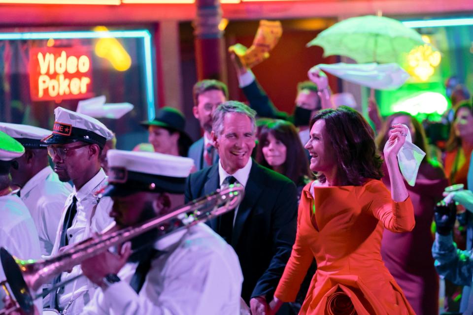 Newlyweds Pride (Scott Bakula), left, and Rita (Chelsea Field) take part in a Second Line parade, a New Orleans tradition, in the series finale of CBS' "NCIS: New Orleans."