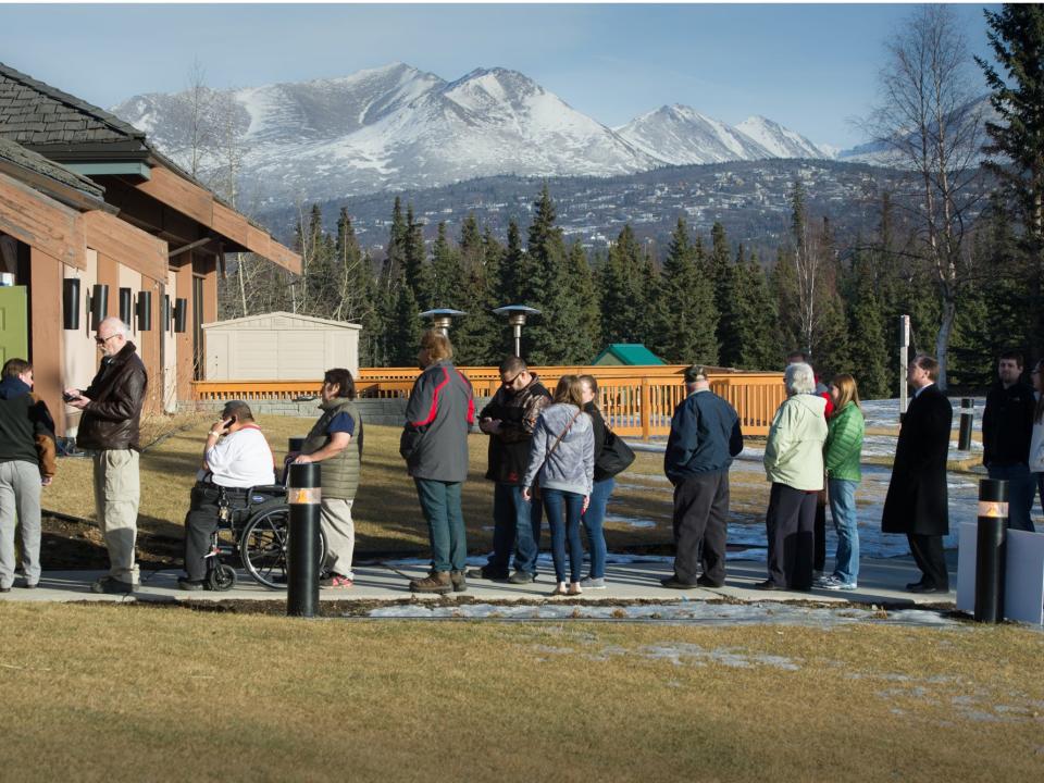 Voters line up outside a polling place Tuesday, March 1, 2016 in Anchorage, Alaska.